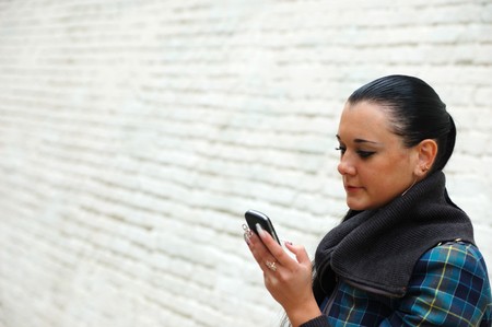 young pretty black haired girl tolking on cell phoneの写真素材