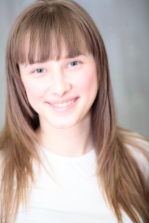 Portrait of a relaxed young woman smiling in living roomの写真素材