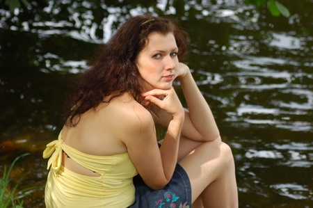 cute girl near the water outdoors closeupの写真素材