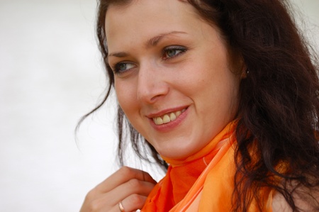 summer - beautiful female outdoors in the park in orange scarfの写真素材