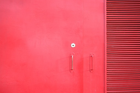 metal door of the red color with keyhole and handlesの写真素材