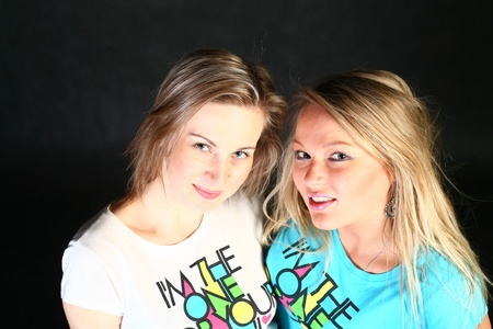 two 20-25 years women  friends having fun in studio