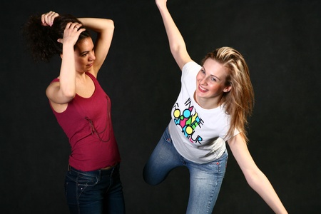 blond and brunette having fun   sensual women studio shot