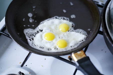 Broken egg frying in a panの写真素材