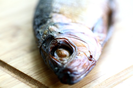 smoked fish on desk on  white background