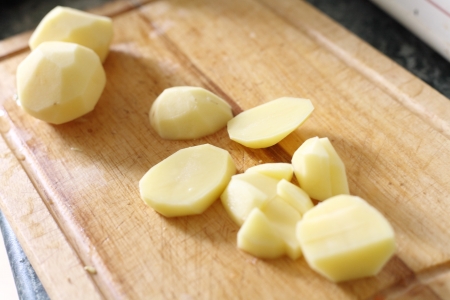 Sliced potato tubers leaves on deskの写真素材