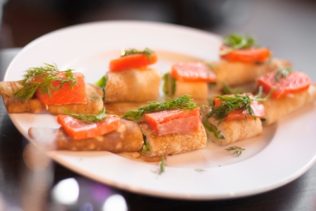 Fresh salmon sandwich on a plate close up