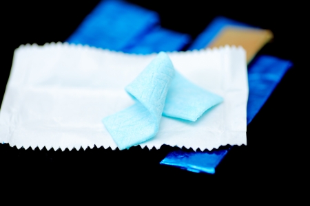 chewing gum partly opened, on black backgroundの写真素材