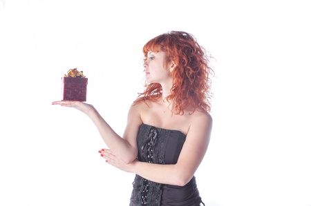 pretty red-haired girl with giftbox on whiteの写真素材
