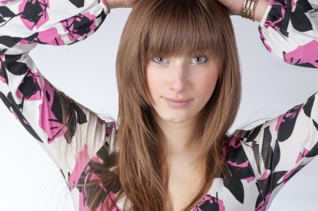 A blond model in the studio wearing a colorful dressの写真素材