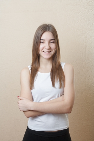 pretty yound slim woman smiling torso shot on white background in sport form indoors health conceptの写真素材