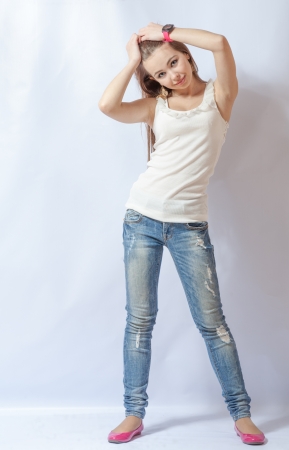 Full length portrait of a caucasian blond woman on gray backgroundの写真素材