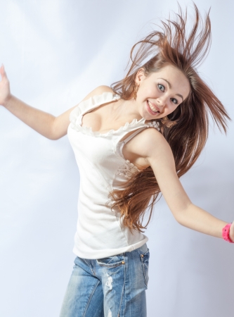 Pretty 20-24 years old blonde girl with great fly-away hair on white backgroundの写真素材