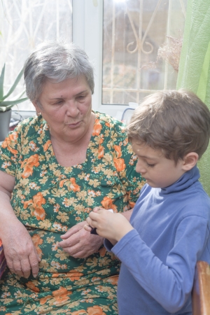 Portrait of a happy little boy near his grandmothersの写真素材
