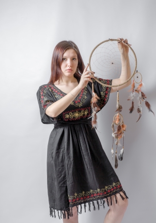 Indian girl in traditional Indian wear and dream catcher posing to the cameraの写真素材