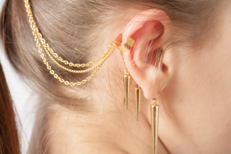 Woman ear with earring white backgroundの写真素材