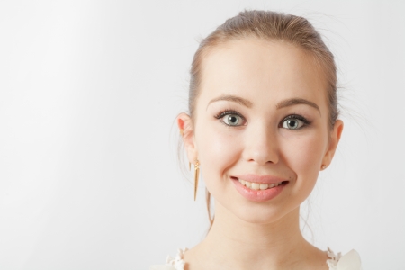 Young woman 20-24 years old looking at camera on white  Fun and joy with toothy smile white backgroundの写真素材