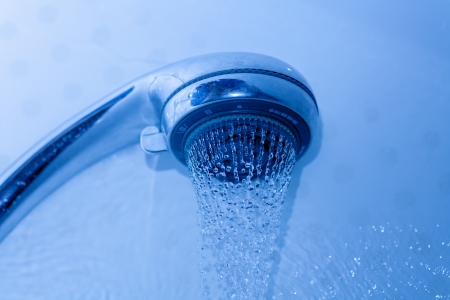 Photograph of a shower head water drops with bokhe sparkles and streams of water  Shower and flying water drops の写真素材