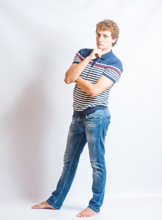 Young man in casual clothes posing over white background full body shotの写真素材