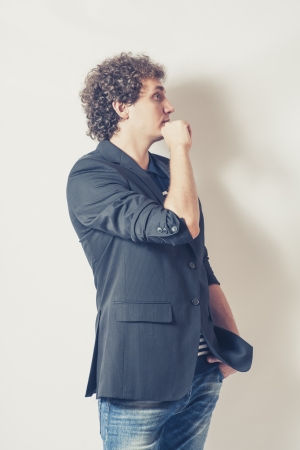 Beautiful guy standing  on white background looking awayの写真素材