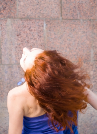 redhead 20s women in blue tank top and skirt dancing salsa outdoor in loneliness, summertime, dayの写真素材