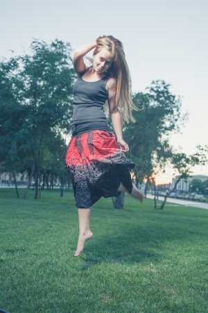 City ballet. Lonely dacer performing alone. Girl jumping like flying bird.の写真素材