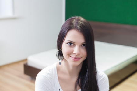 brunette indoors sitting against living roomの写真素材