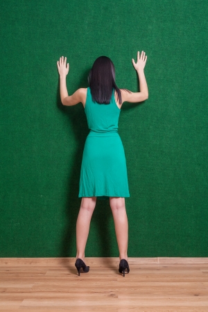 Backview shot of gesturing brunette  Backside image of lady weared green dressの写真素材