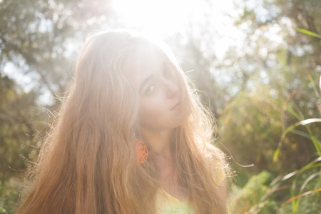 Backlit image of the pretty blonde outdoors. Colorized imageの写真素材