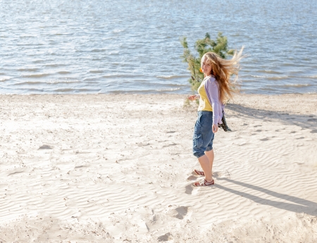 beautiful girl walk in the morning on the beach.の写真素材