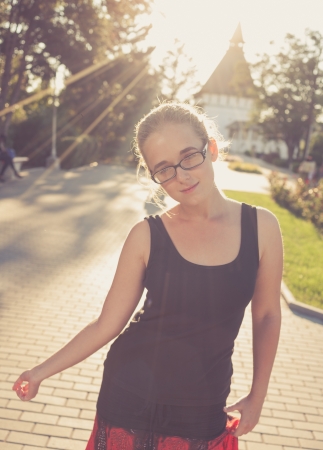 young 20s blond haired women posing outdoors weared black tank top in glasses  Shi is very pretty and fresh looking  Cute young lady outdoors rejoice of warm weather fallの写真素材