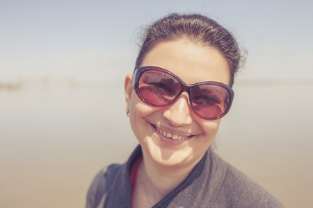 Outdoor candid closeup portrait of 30s pretty woman in spring sunny day outdoorsの写真素材
