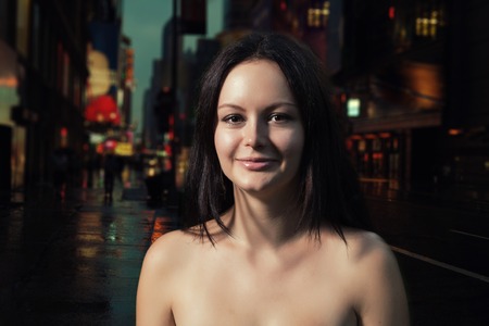 Shirtless brunette smiling in the night street. Outdoors shotの写真素材