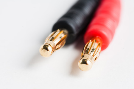 Couple of golden electric plug jacks of red and black colorの写真素材