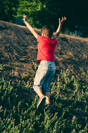 Small boy climb up slope.の写真素材