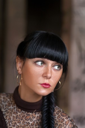 Braided black haired women looking away outdoors shot.の写真素材