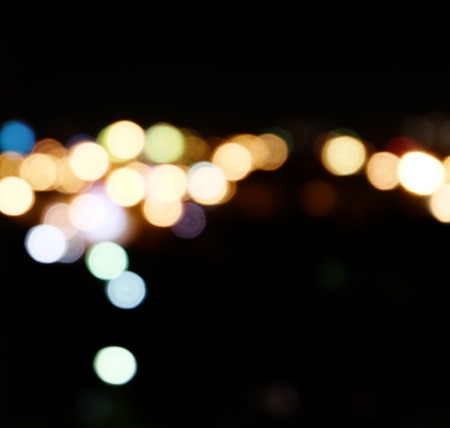 City lights in the background with blurring spots of  light a lot of copyspace.
