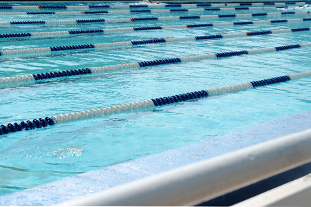 Lanes of swimming pool over light blue transparent  water
