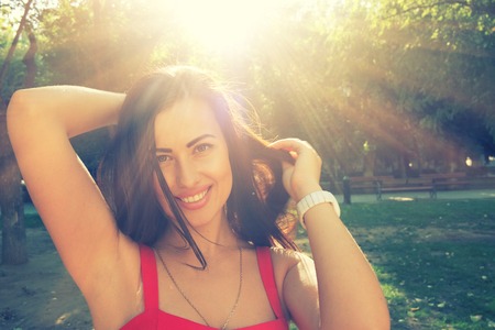 Young smiling women with sun at backgroundの写真素材