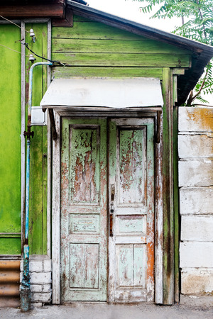 Ancient wooden door in old house wall. Astrakhan, Russia.の写真素材