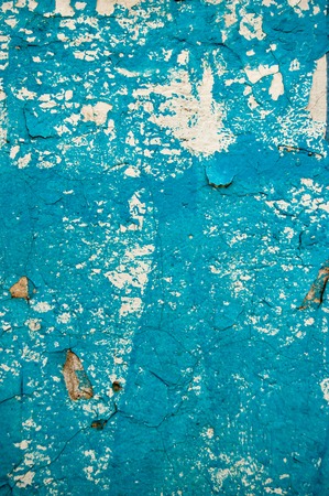Old weathered wall painted in scratched blue color.の写真素材