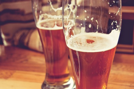 Half-full glasses of beer toned image.の写真素材