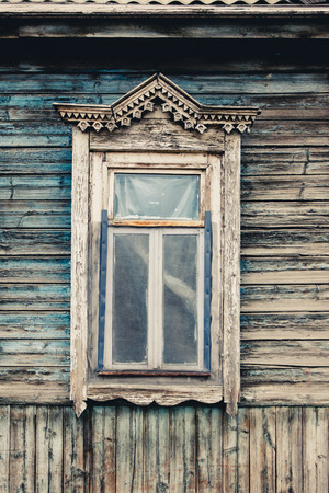 Old wooden window. Russian traditional style toned photographの写真素材