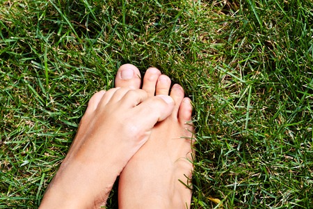 Funny Foot over green grass Closeupの写真素材