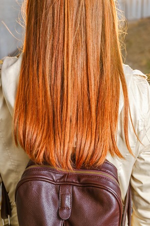 Rear view of redhair teen girl with backpackの写真素材