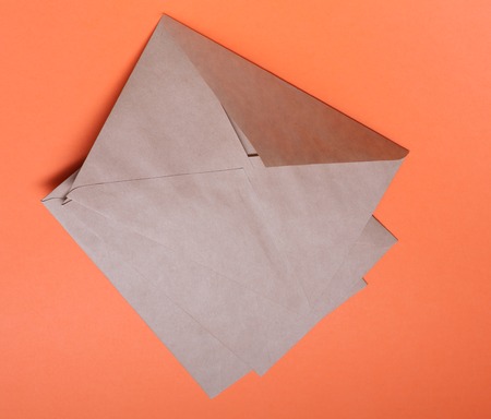 Brown envelops on bright orange backgroundの写真素材