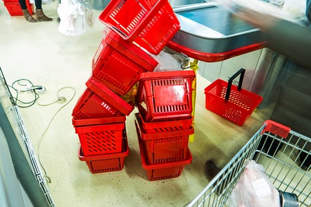 Red plastic supermarket shopping basketsの写真素材