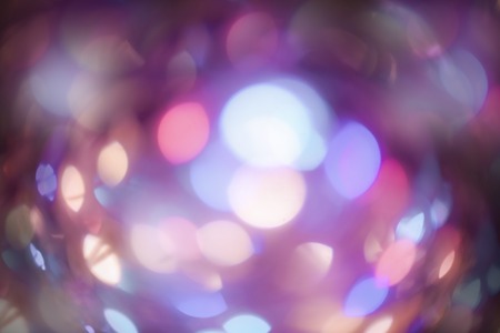 Violet blurred wallpaper. Christmas lights defocused background. Vintage styled holiday abstract bokeh retro imageの写真素材