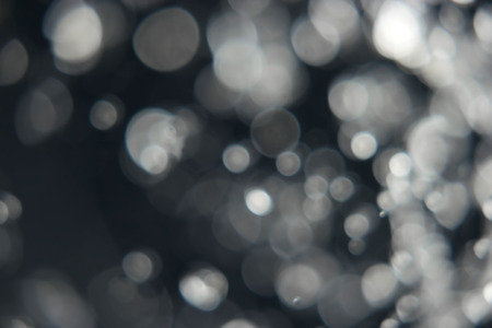 Blurred snow flaces. Glitter bokeh lights bokeh defocused background