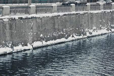 Clear water and concrete walls of Neva Embankment, St. Petersburg, Russia.の写真素材